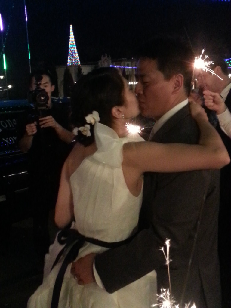 Bride and groom kissing at the prado balboa park